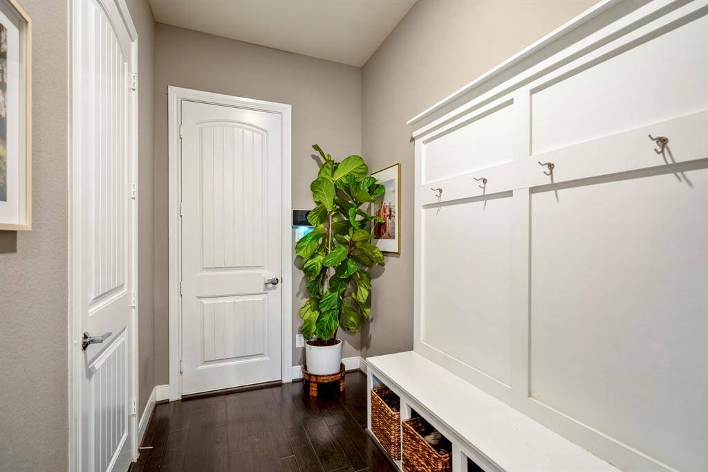 Just off the kitchen you will find a spacious mud area that leads to the garage! It's completed with a custom bench and hooks for storage, wood floors, and recessed lighting.