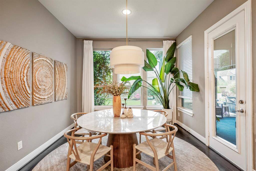 Start your day off right with a cup of coffee sitting with your family in the breakfast area! Featuring large windows, neutral paint, beautiful flooring, custom lighting, and access to the covered back patio!