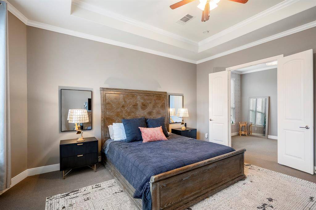 Come relax in the primary retreat with trace ceilings, crown molding, a ceiling fan, and direct access to your ensuite primary bathroom! It connects to the primary bathroom through the additional room, perfect for a home gym, dressing room, or reading space!