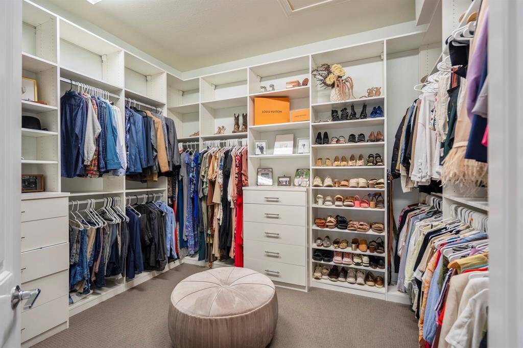 Storage meets style in this custom primary closet! Designed with built-ins and ample space, this walk-in sanctuary keeps everything beautifully organized while adding a touch of luxury to your daily routine.