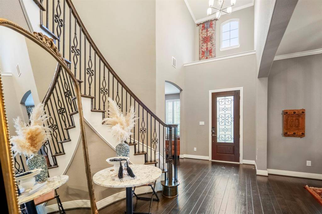 Another look at the open and grand entryway—an impressive welcome to the home. Head upstairs to discover a spacious game room, a dedicated media room, and three generously sized secondary bedrooms, perfect for family or guests.