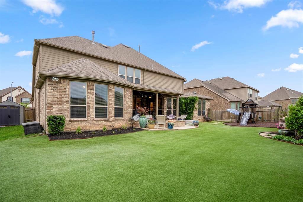 Enjoy the outdoors in this spacious and low-maintenance backyard upgraded with artificial turf! With plenty of room for play, gardening, or relaxing, this private outdoor space is ready to go!