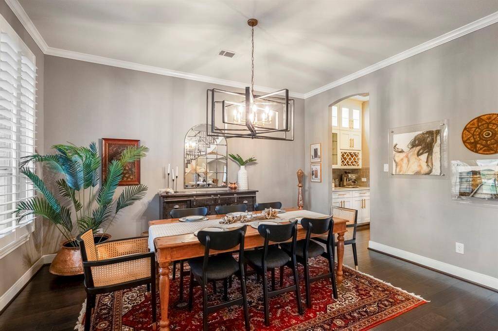 Make memories gathered around the table with your family and friends! This dining room conveniently connects to the kitchen through the butler's pantry and features high ceilings, crown molding, large windows, and a beautiful chandelier!
