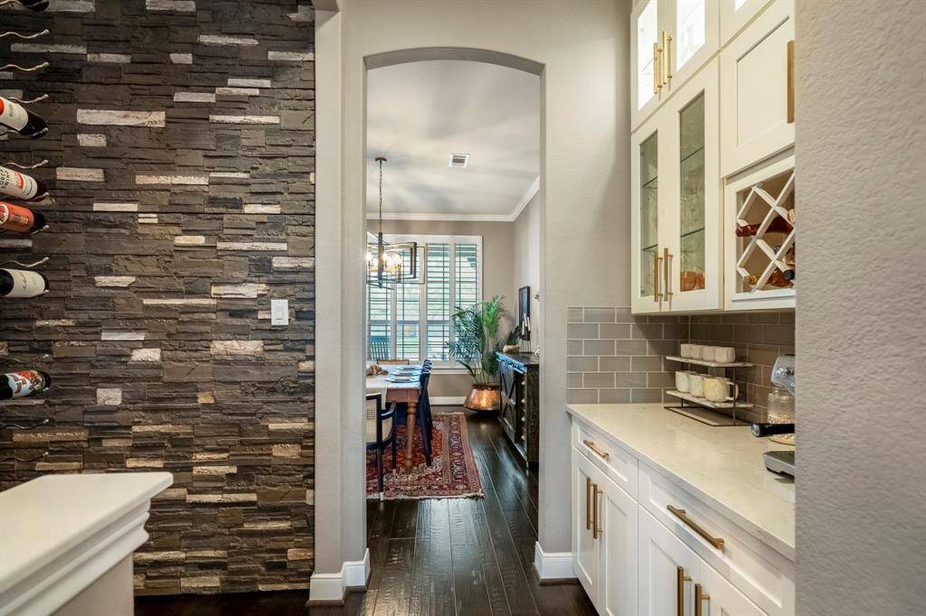 This charming coffee nook & wine space is the perfect blend of function and style, featuring built-in storage, wine racks, and plenty of room for your favorite bottles & brews. Whether you're starting your day with coffee or winding down with a glass of wine, this space has you covered!