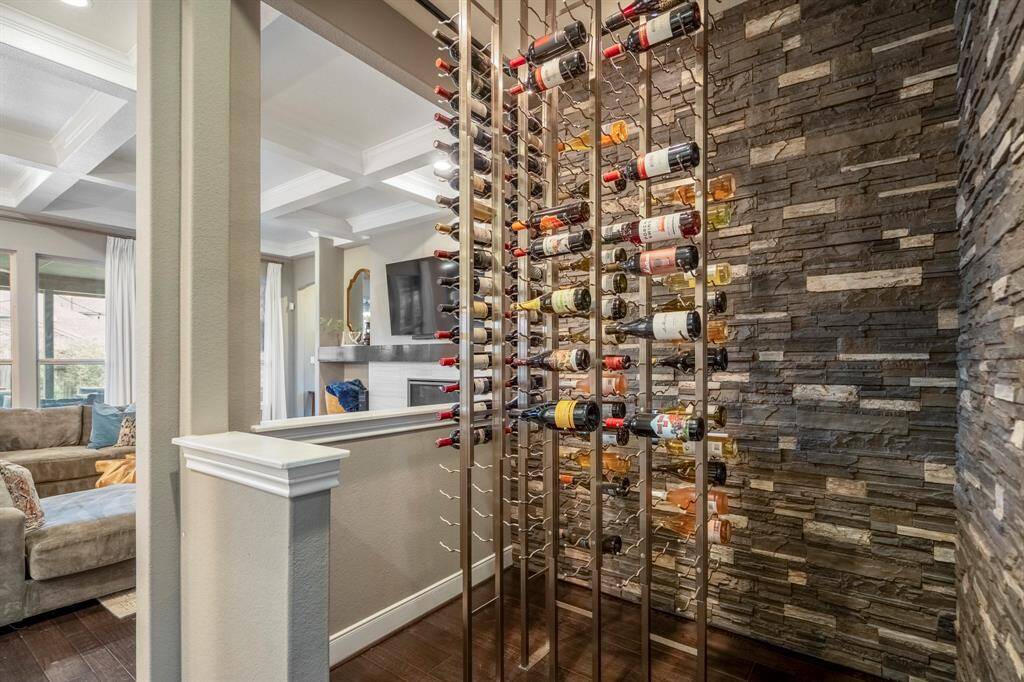 Thoughtfully integrated into the living space, this wine cellar blends modern design with timeless elegance, creating a striking focal point. Whether you're storing a prized collection or showcasing a few select vintages, this display invites conversation and enhances the home's overall aesthetic.