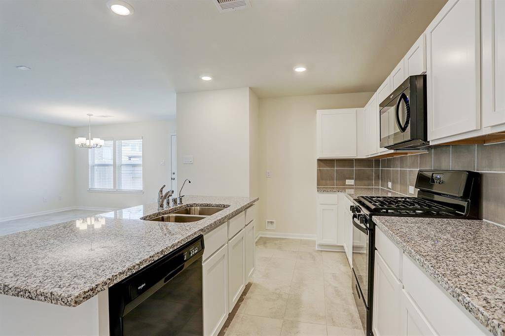 The kitchen with gorgeous granite counter tops and walk in pantry.