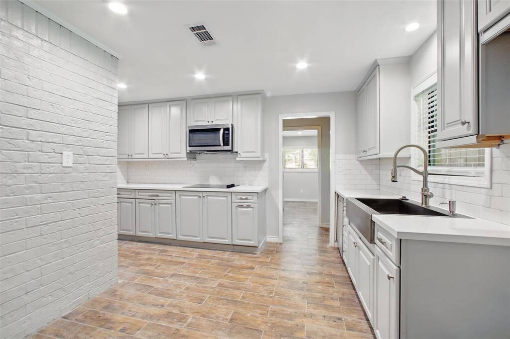 The heart of the home is fully updated with durable quartz counters, stylish cabinetry, and brand-new stainless steel appliances that bring a polished look to every detail.