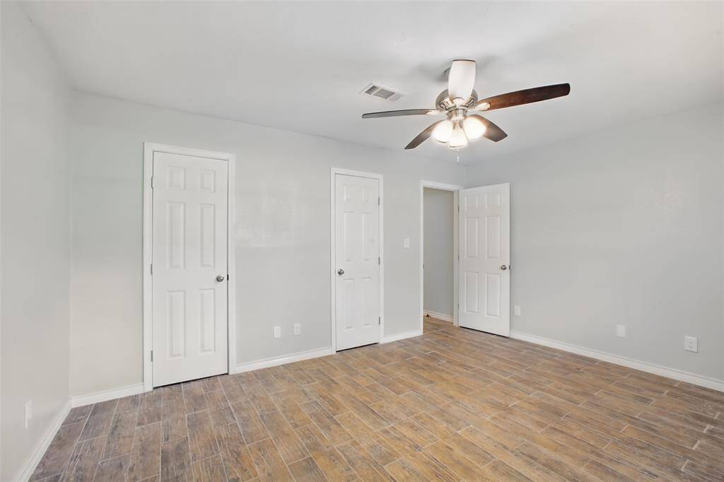 The primary suite offers space to unwind, with soothing tones, natural light, and a direct connection to a beautifully updated bathroom.