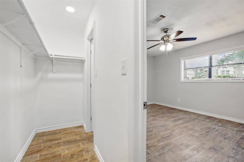 The ideal balance of comfort and privacy, this primary bedroom offers a spacious walk-in closet with shelving and abundant hanging space.
