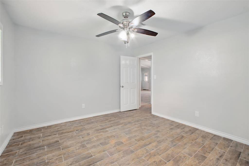 An alternate view of this secondary bedroom reveals its ideal location near the home's main areas, perfect for family, guests, or a home office.