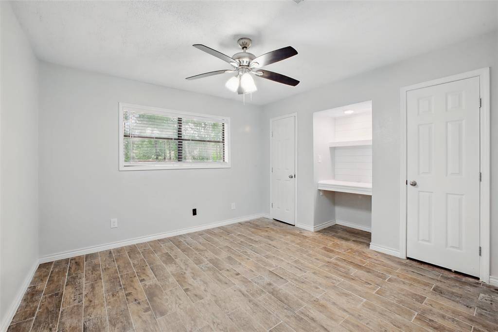 This secondary bedroom offer a balance of function and comfort, with a custom desk nook that's perfect for studying or as a vanity area.