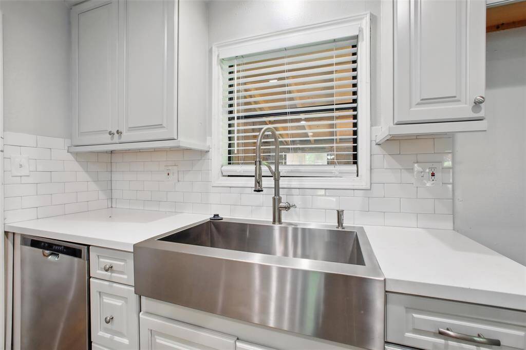 Cook, create, and gather in a kitchen designed for both style and efficiency, with a sleek stainless steel farm sink, recessed lighting, and smart storage solutions.