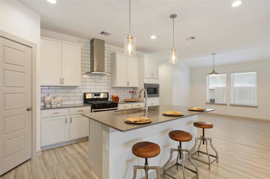 A chef dream's kitchen featuring a center island and a generous walk in pantry. This is the focal point of the home!