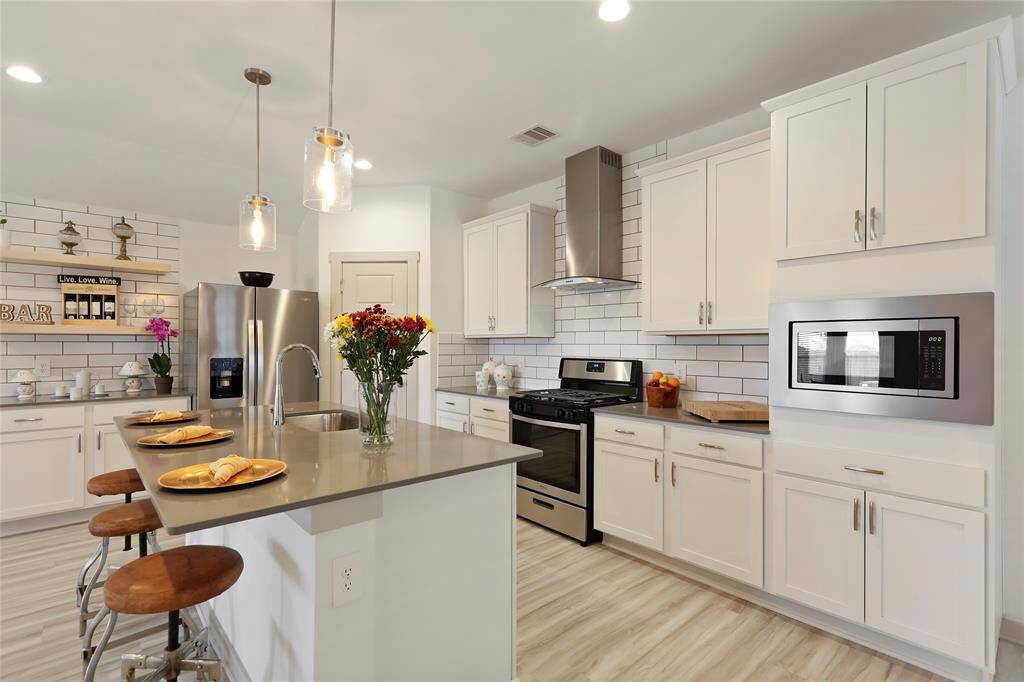 Whirlpool stainless steel appliances including side-by-side refrigerator