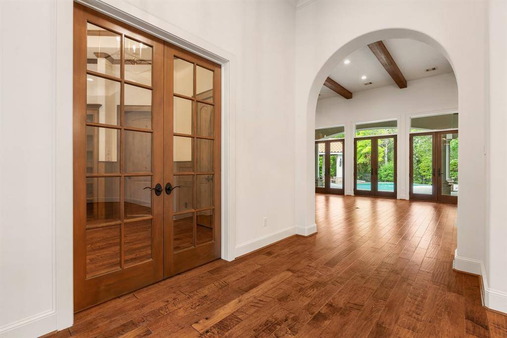Light, neutral paint and mouldings beautifully accent Knotty Alder doors, trim and beams.