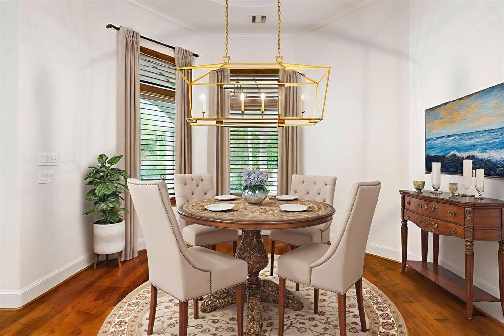 (VS) Breakfast area with dual windows; plantation shutters and updated light fixture is ideal for taking in views of the retreat style backyard.