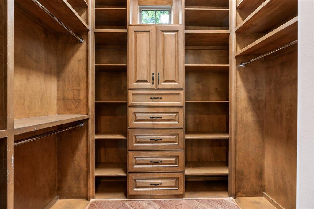 Primary bath features 2 closets offering plenty of beautiful built in storage!