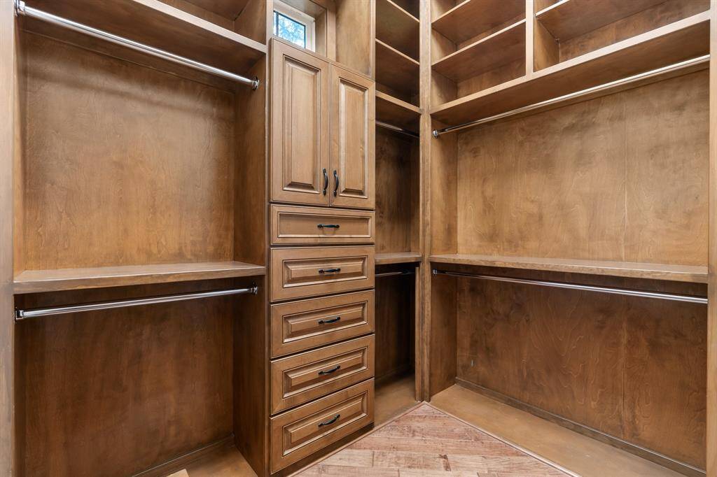 The primary his and her closets also feature a window that allows for natural light.