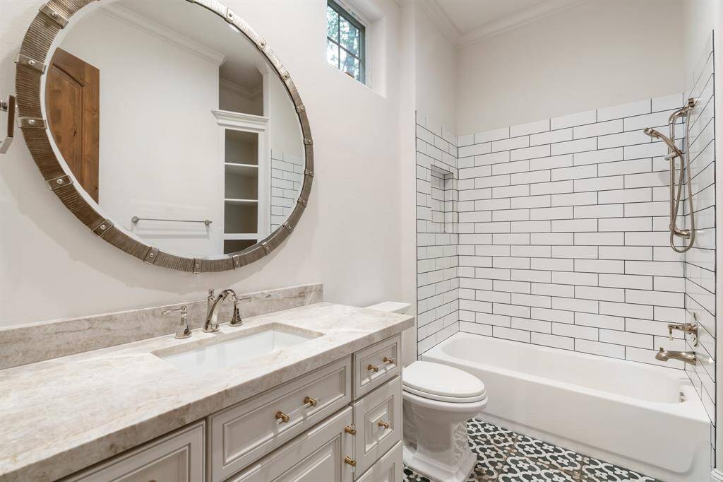 Secondary Bedroom #1 En Suite Bath: highlights an all new tub/shower combination, new antique tile flooring, hardware, quartzite counter ... all the expected comforts!