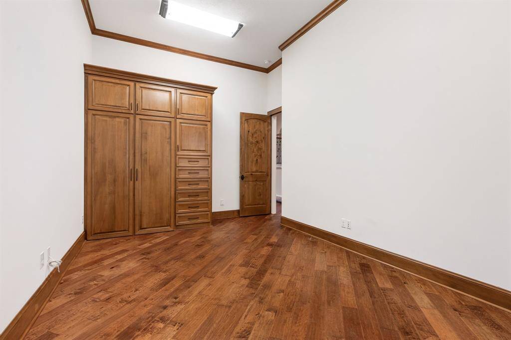 Another view of Bedroom #3 with built-in storage cabinets, and hanging space.