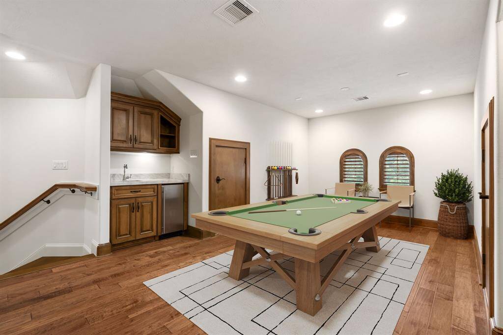 No carpet throughout the entire house! The game room continues with the home's beautiful wood floors, attic access, and fantastic storage. (VS)