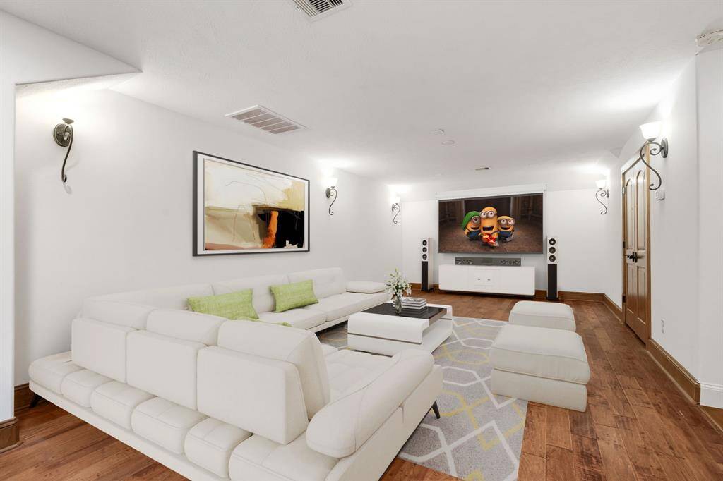 This spacious game or movie room offers built-in storage and versatile potential—perfect as a second office, home gym, or flexible living space to suit your needs. (VS)