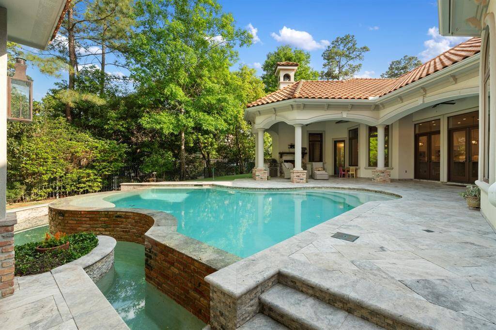 This private, tranquil backyard is nestled among tall trees offering a peaceful retreat for year-round enjoyment.