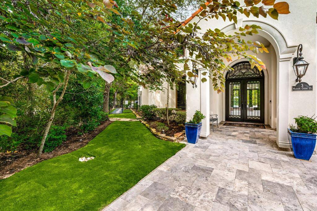Lush lawn and gardens surround the property.