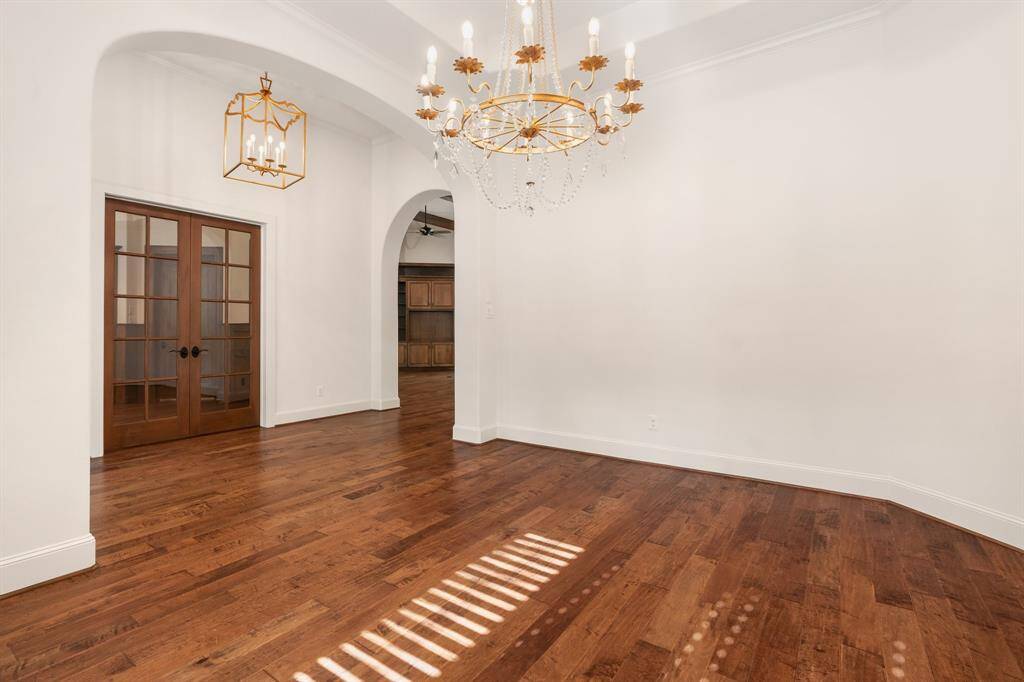 View from the formal dining to the entry and study. Gorgeous updated light fixtures are found throughout.