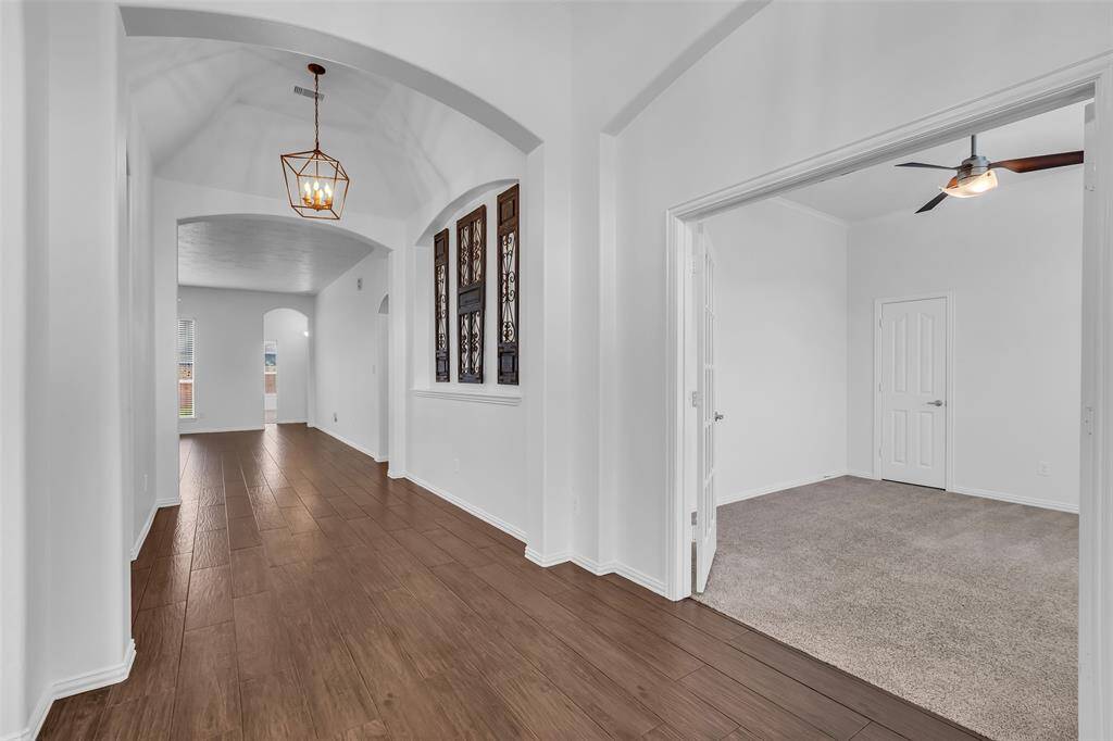 Impressive Arched Entry and Beautiful Wood Floors
