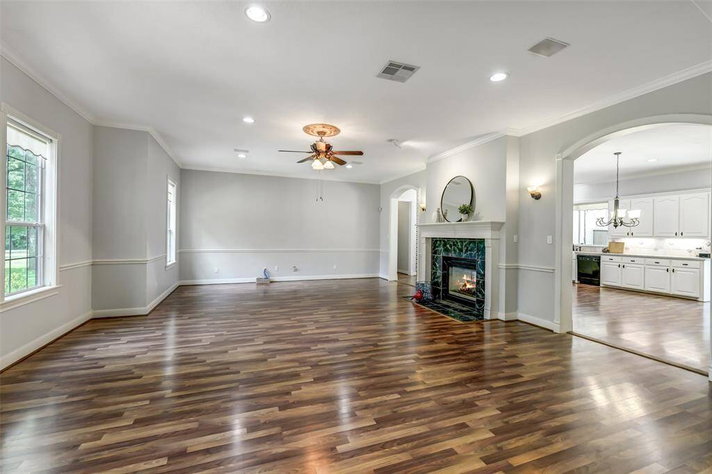 Grand living space features a double sided fireplace, crown molding, fresh paint, canned lights, beautiful windows overlooking front of property. We love the two arched entries to the kitchen. Perfect for parties and get togethers.
