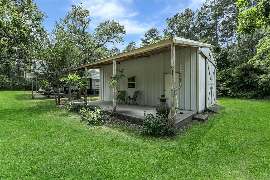 30x30 Barn with a large covered porch. Covered RV and Boat storage parking on the other side of the barn.