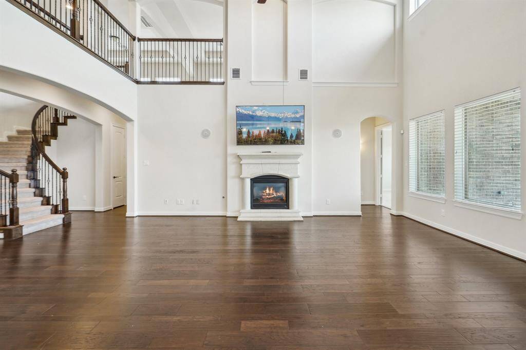Primary suite is to the right of the classic cast stone fireplace. Large closet under the stairs and secondary bedroom with ensuite bath is just down the hall.