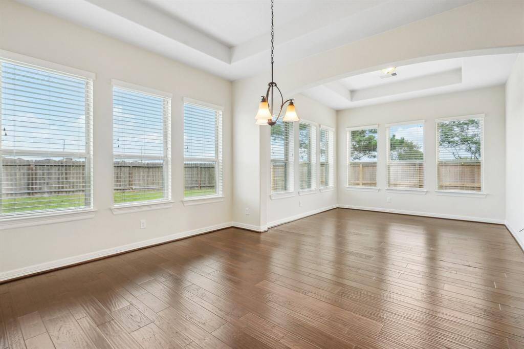 Breakfast room with tray ceilings and view into enclosed sun room or morning room. A flex room that could be a peaceful yoga or art studio or a library. What an opportunity for your imagination.