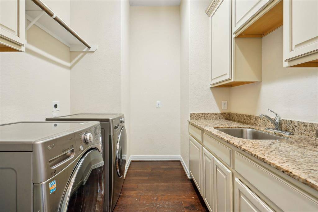 Just off the kitchen is the laundry room with maximum extra storage cabinets, large sink, and a special spot just for the second fridge.