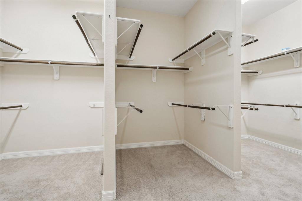 A large walk-in closet offers plenty of space for everything.