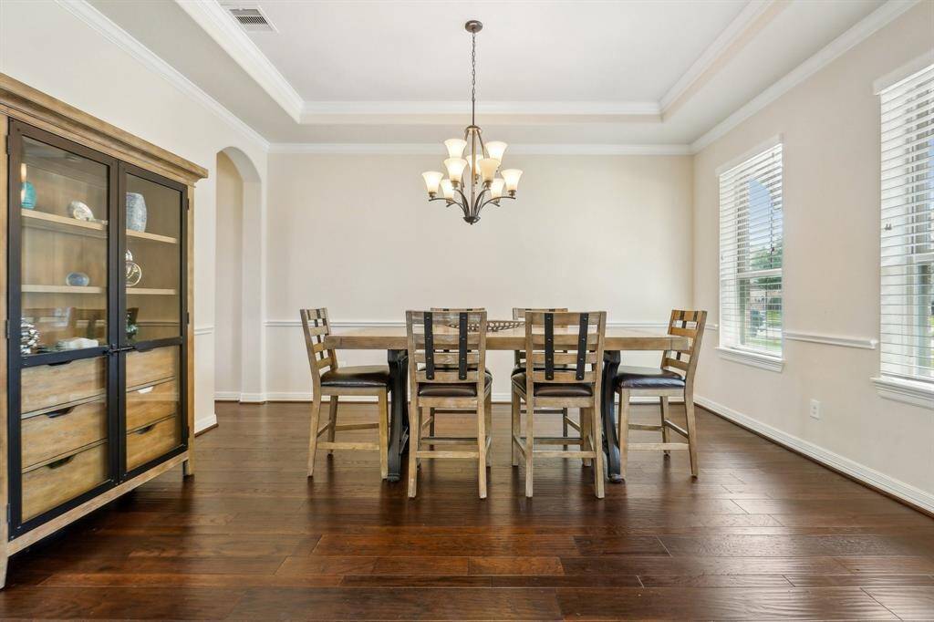Deluxe dining with tray ceilings, chair railing, and crown molding. Room for the largest of tables and sideboards.
