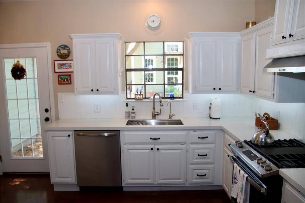 This thoughtfully designed kitchen balances charm and function with a farmhouse sink, updated fixtures, and views into the backyard