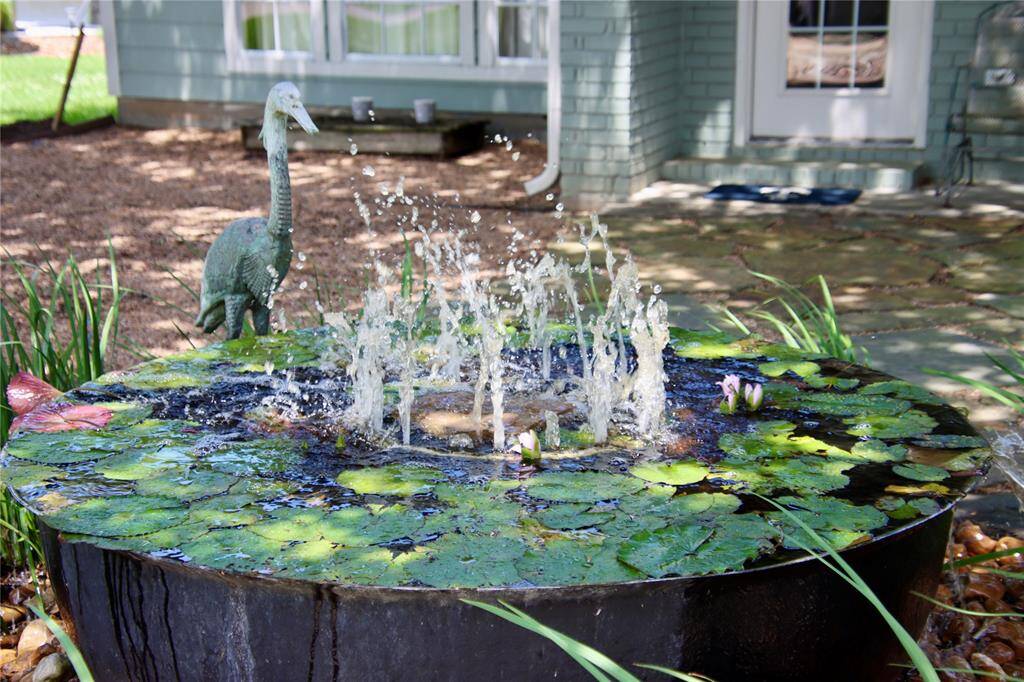 A tranquil lily-filled fountain sets the tone for peaceful mornings and serene evenings in the courtyard garden.
