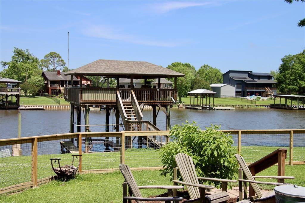A two-tiered dock with covered lounge, boat lifts, and swim access offers the ultimate setup for riverfront living.