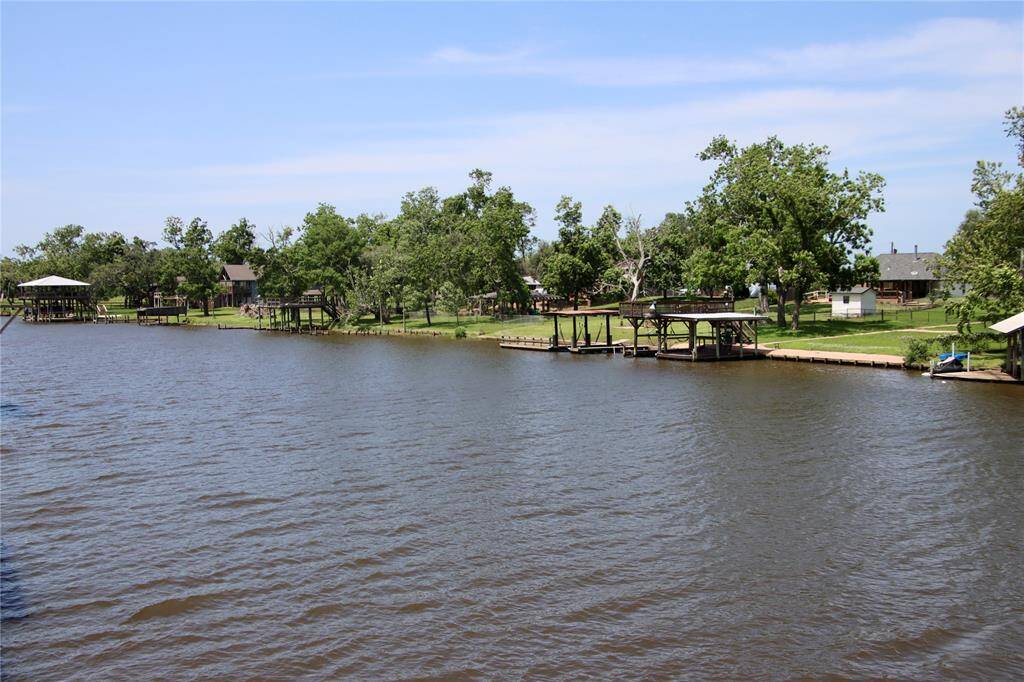 A peaceful stretch of the San Bernard River lined with docks and tree-filled yards—quintessential Texas waterfront charm.