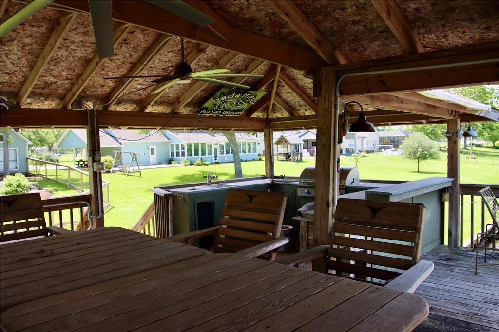 Enjoy the shade and a cross-breeze from your own outdoor kitchen and bar, perched above the water with room for everyone.