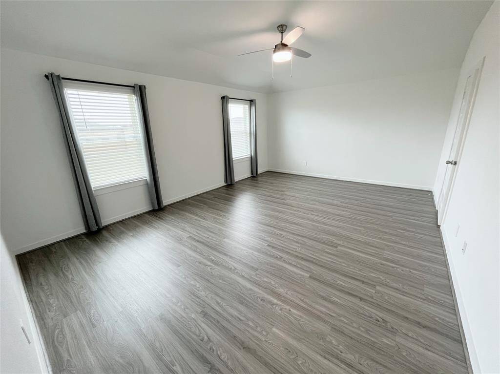 Primary Bedroom with an elevated ceiling