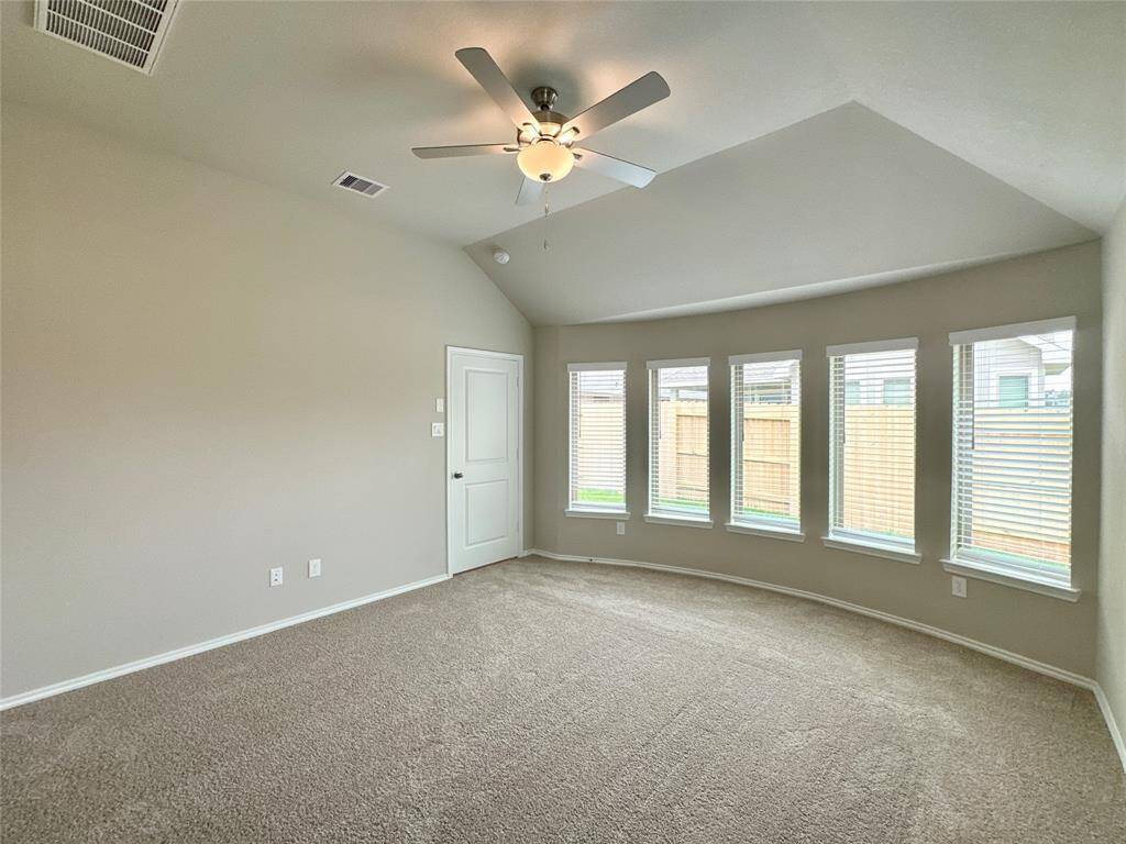 The primary bedroom features stunning windows that allow an abundance of natural light flood the space.