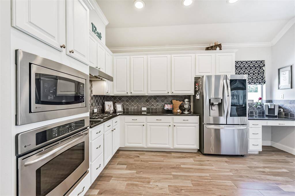 Oven, microwave, and refrigerator crafted from sleek stainless steel.