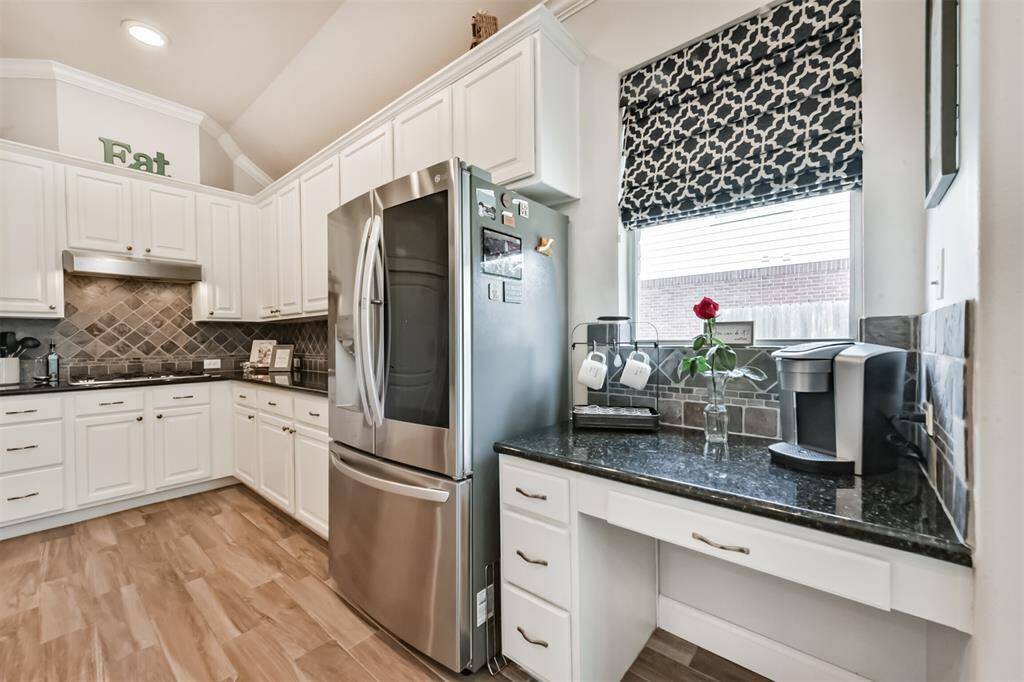 Chef's desk and stainless steel refrigerator.