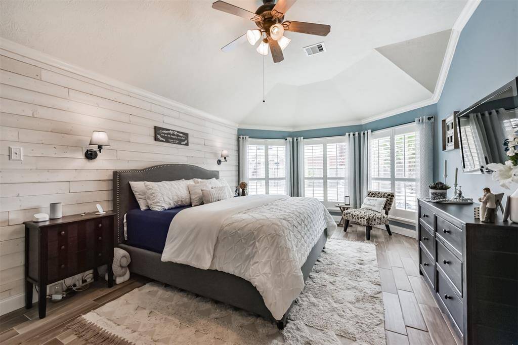 Spacious primary bedroom featuring soaring ceilings