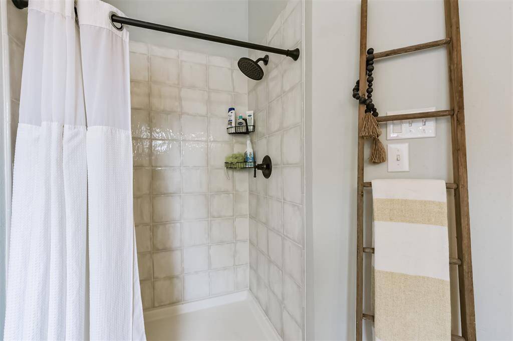 Separate tile accented walk-in shower.