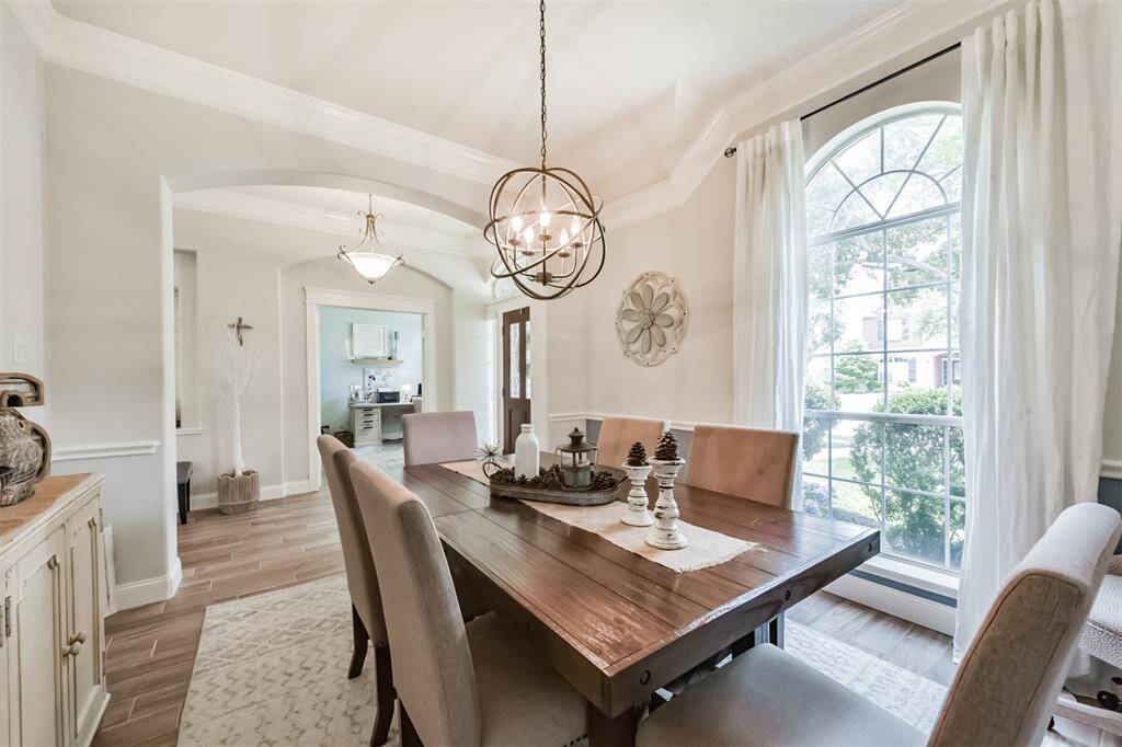 An elegant arched entryway welcomes you into the formal dining room.
