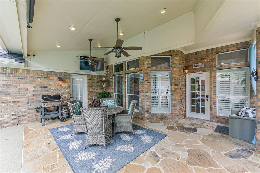 A covered patio and breezeway provide seamless protection from the elements.